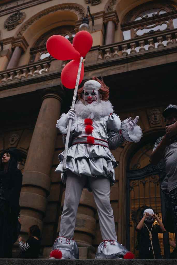 scary clown with red balloons