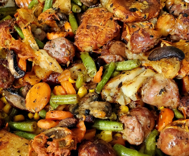 Baked sausage and potatoes with a selection of vegetables